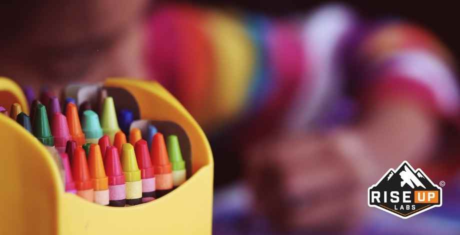 a child drawing with color pencils in the front